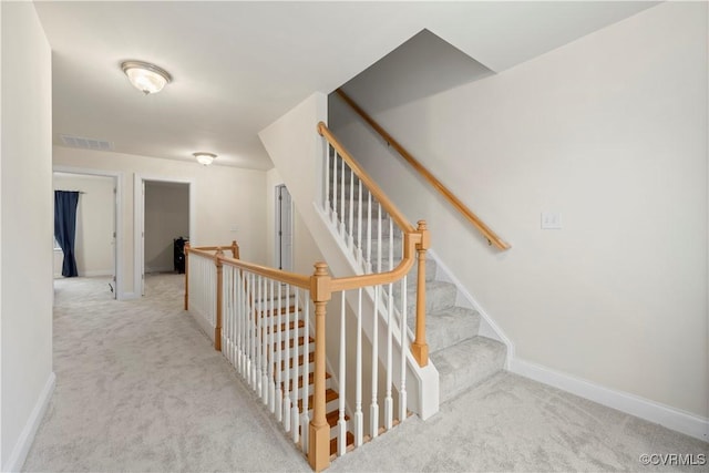 stairs featuring carpet floors, baseboards, and visible vents