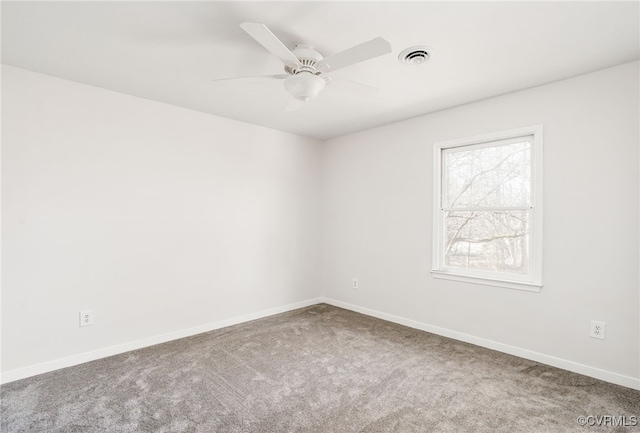 empty room with a ceiling fan, carpet, visible vents, and baseboards