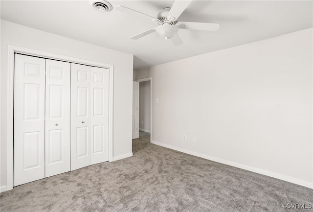 unfurnished bedroom featuring visible vents, ceiling fan, baseboards, carpet, and a closet