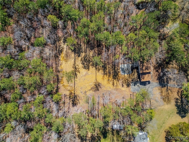 birds eye view of property featuring a view of trees