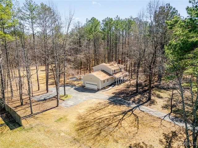 birds eye view of property with a forest view