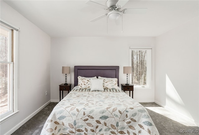 carpeted bedroom featuring multiple windows and baseboards