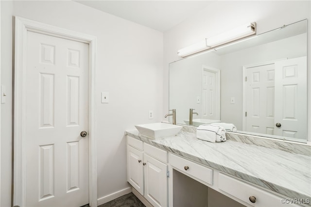 bathroom with vanity and baseboards