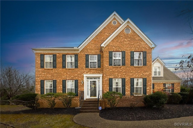 colonial home with brick siding