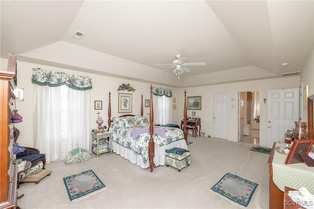 bedroom featuring light colored carpet, a raised ceiling, visible vents, and lofted ceiling