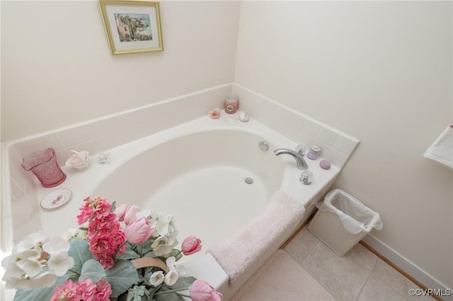 bathroom with tile patterned floors and a bath