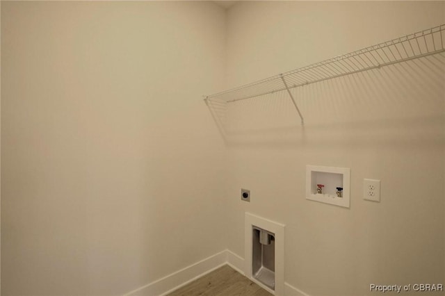 laundry room with hookup for a washing machine, hookup for an electric dryer, wood finished floors, laundry area, and baseboards