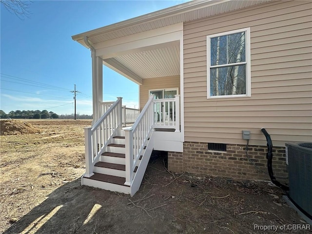 view of side of property featuring crawl space and central air condition unit