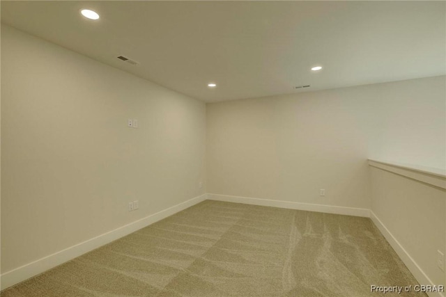 unfurnished room with recessed lighting, light carpet, visible vents, and baseboards