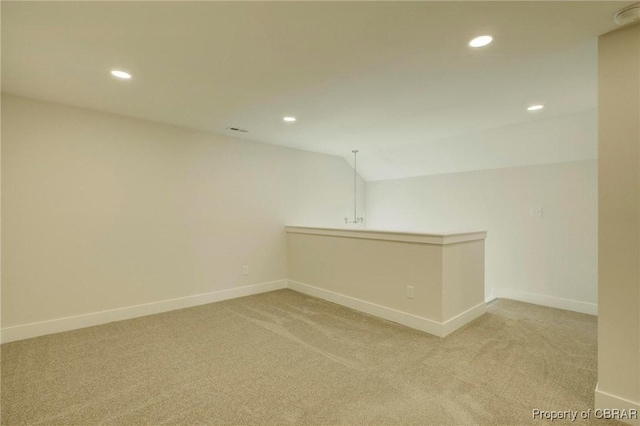 empty room with recessed lighting, light carpet, and baseboards