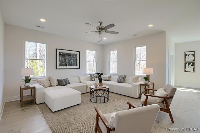 living area with recessed lighting, a healthy amount of sunlight, visible vents, and light wood finished floors