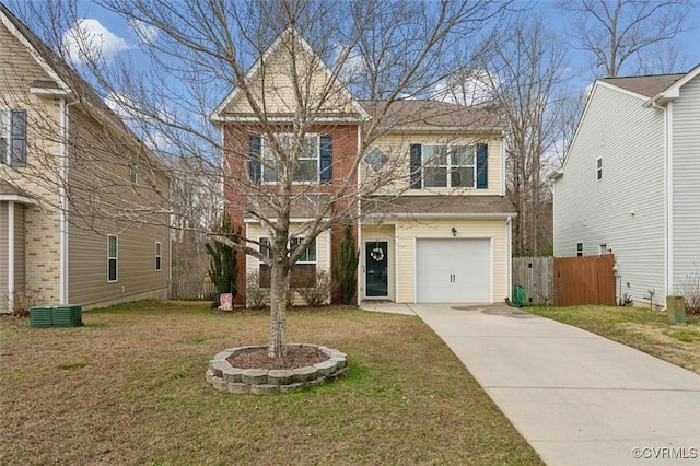 traditional home with a garage, concrete driveway, a front lawn, and fence