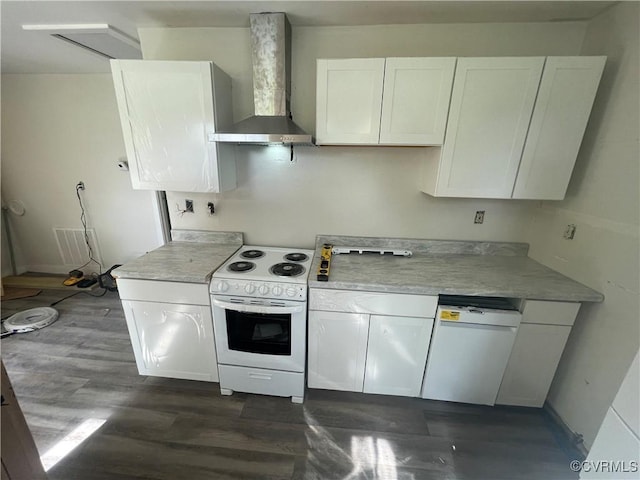 kitchen featuring wall chimney exhaust hood, white appliances, light countertops, and white cabinets