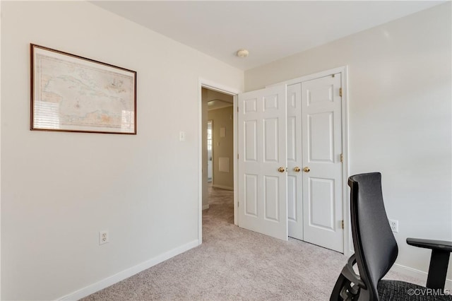 unfurnished office featuring carpet floors and baseboards