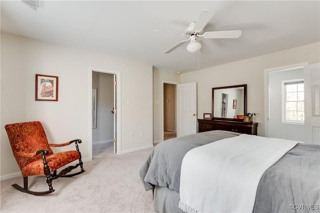 bedroom with light colored carpet, ceiling fan, and baseboards