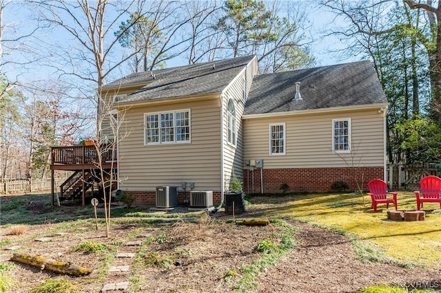 rear view of house featuring stairway, an outdoor fire pit, central AC, fence, and a wooden deck