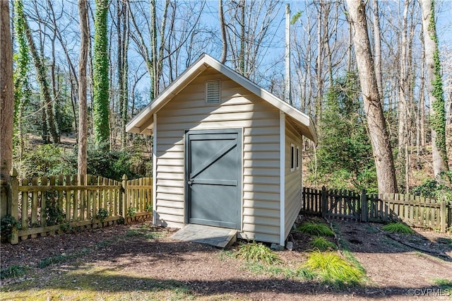 view of shed featuring fence