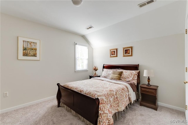 bedroom with lofted ceiling, visible vents, and light carpet