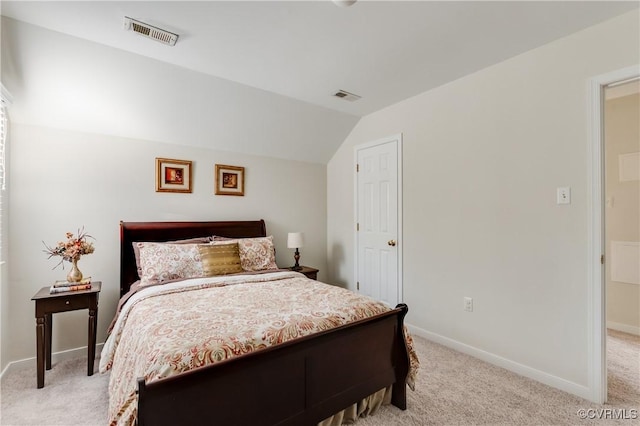 bedroom featuring vaulted ceiling, visible vents, and light colored carpet