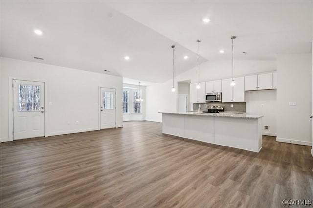 kitchen featuring a wealth of natural light, appliances with stainless steel finishes, dark wood finished floors, and white cabinetry