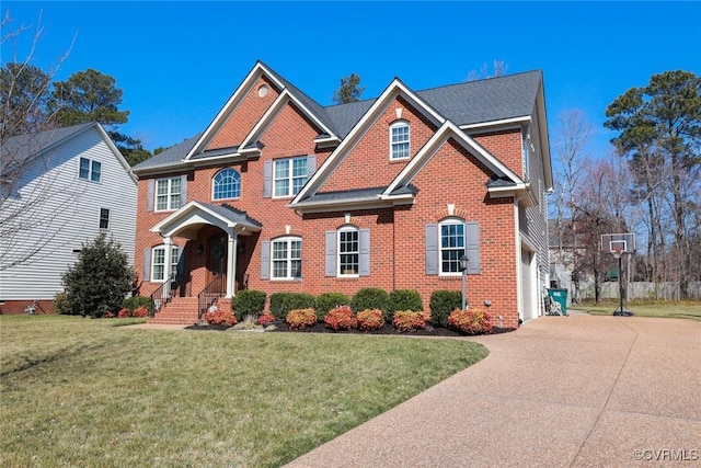 view of front of property featuring a garage, brick siding, concrete driveway, and a front yard