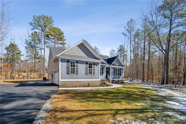 view of front facade with a garage, driveway, a front lawn, and board and batten siding