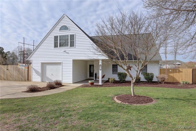 traditional-style house featuring driveway, fence, covered porch, an attached garage, and a front yard