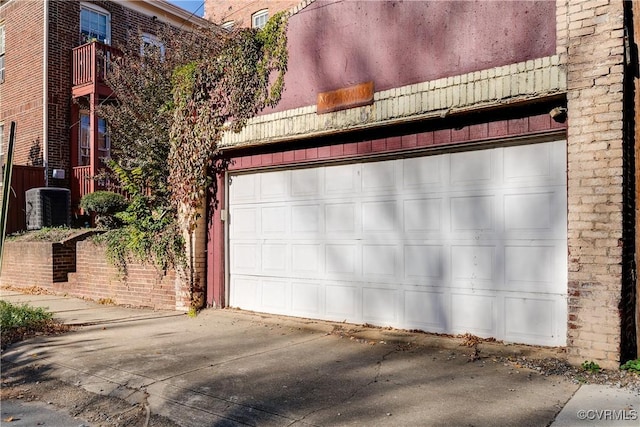 garage featuring central AC and concrete driveway