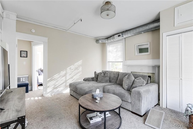 living room with a fireplace and light colored carpet