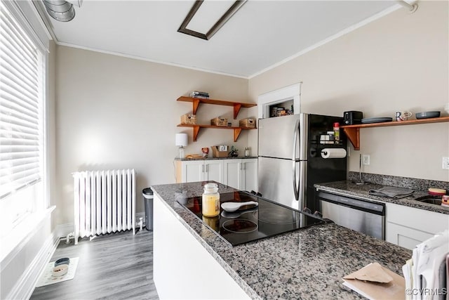 kitchen with open shelves, radiator, appliances with stainless steel finishes, ornamental molding, and white cabinetry