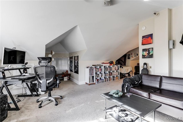 office space with carpet, baseboards, and vaulted ceiling