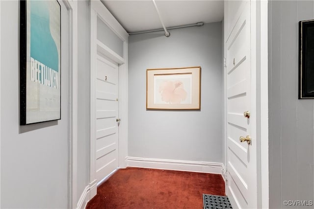 spacious closet featuring dark colored carpet