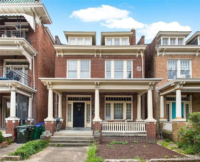 view of front of property with a porch and brick siding