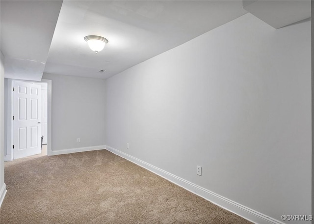 spare room featuring carpet floors and baseboards