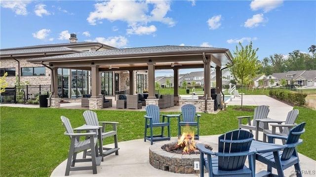 exterior space featuring fence, a fire pit, and a gazebo