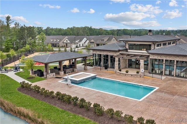 pool with a patio, a gazebo, fence, and a residential view