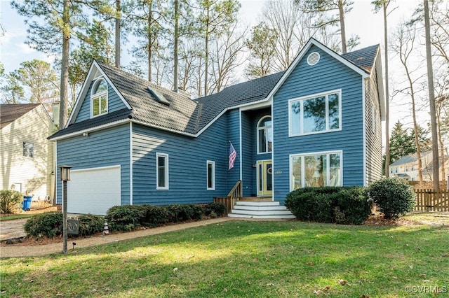 view of front facade with a front yard, an attached garage, and fence