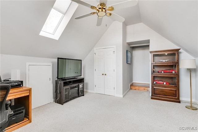 additional living space featuring baseboards, light carpet, a ceiling fan, and vaulted ceiling with skylight