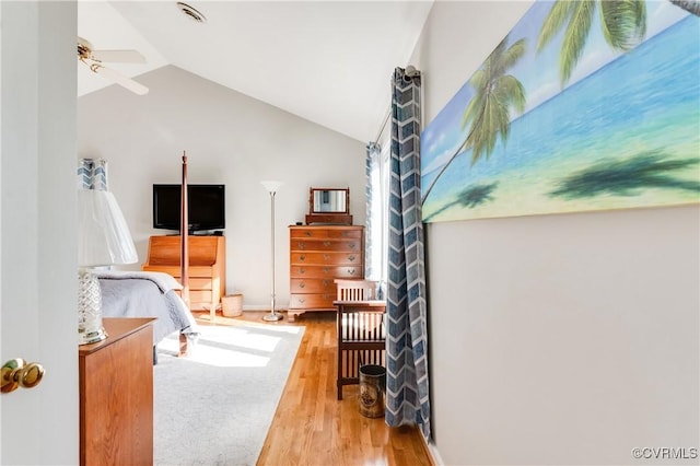 bedroom featuring lofted ceiling and wood finished floors