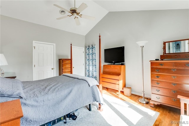 bedroom with vaulted ceiling, wood finished floors, and ceiling fan