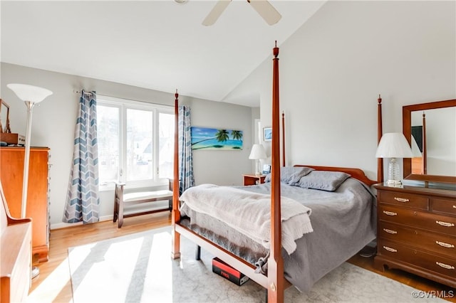 bedroom with light wood finished floors, high vaulted ceiling, and a ceiling fan