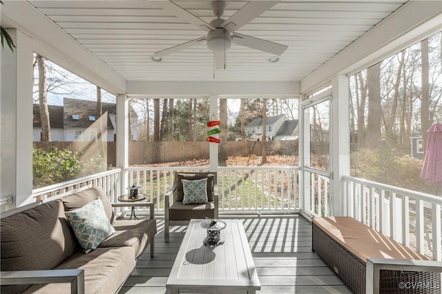 sunroom / solarium featuring ceiling fan