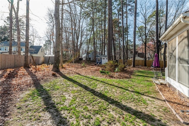 view of yard featuring an outdoor structure and fence