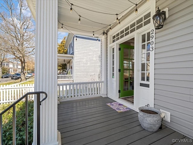 deck with a porch and fence