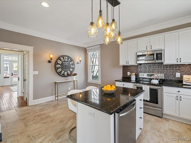 kitchen featuring crown molding, stainless steel appliances, and backsplash