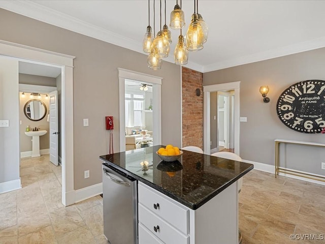 kitchen featuring baseboards, a kitchen island, white cabinetry, and crown molding