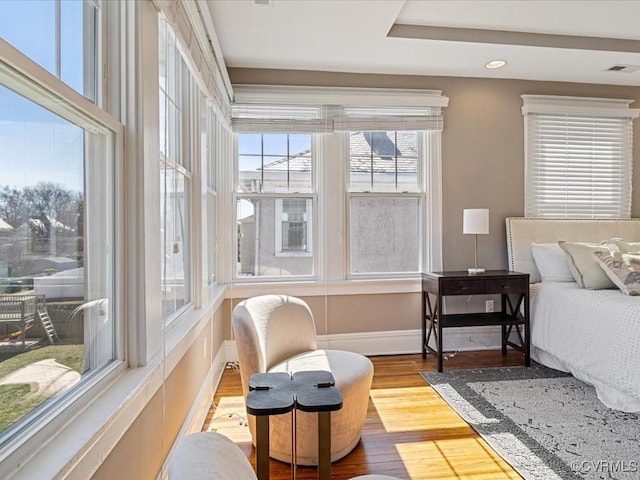 bedroom with baseboards, visible vents, wood finished floors, and recessed lighting