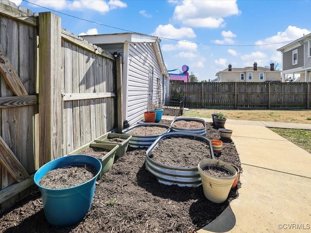 view of yard featuring a fenced backyard and a vegetable garden