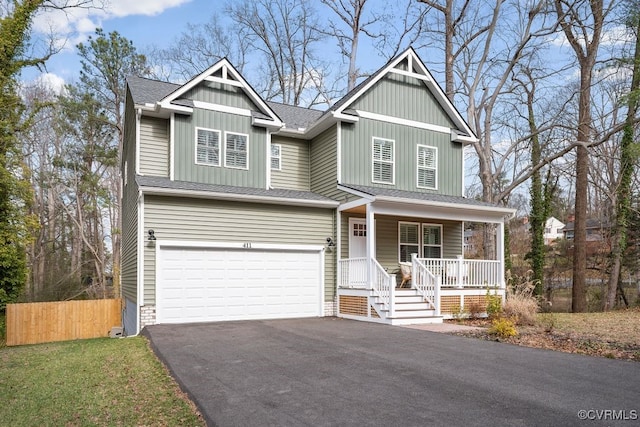 view of front of house featuring driveway, a shingled roof, an attached garage, fence, and a porch