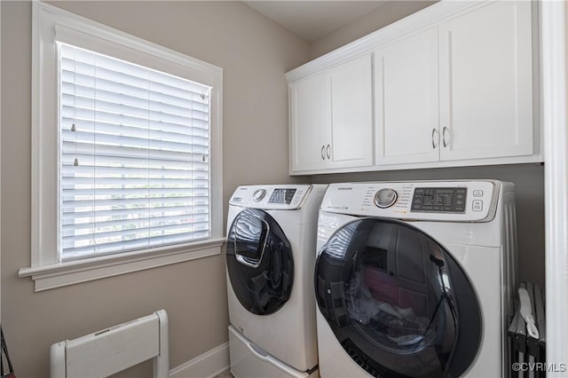 clothes washing area with cabinet space and separate washer and dryer